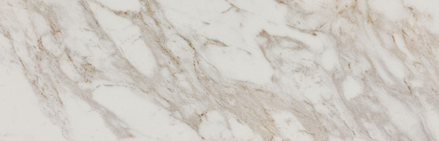 White marble surface with subtle gray and beige veining patterns.